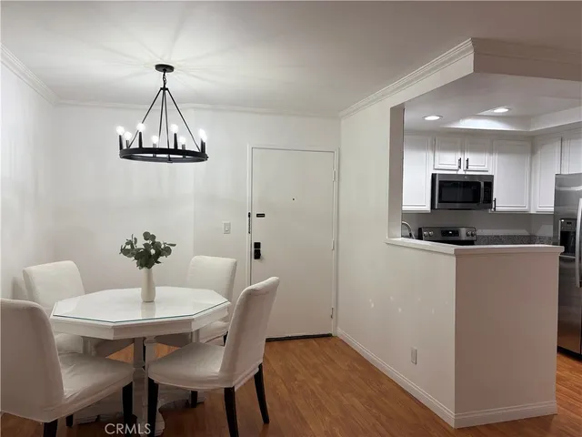 a view of a dining room with furniture wooden floor and chandelier