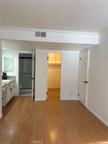 wooden floor in an empty room and a kitchen