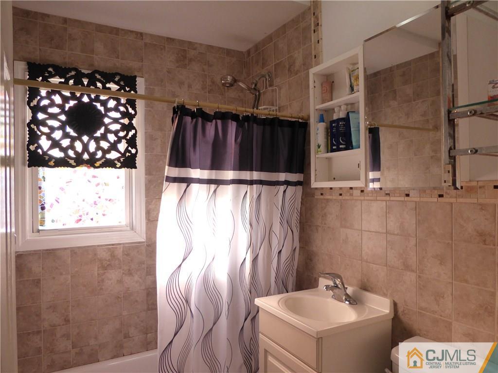 20 Miko Road Edison, NJ 08817 - Photo 11 of 19 a bathroom with a sink toilet and shower