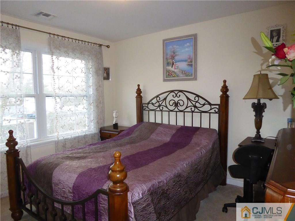 20 Miko Road Edison, NJ 08817 - Photo 14 of 19 a bedroom with a bed and wooden floor