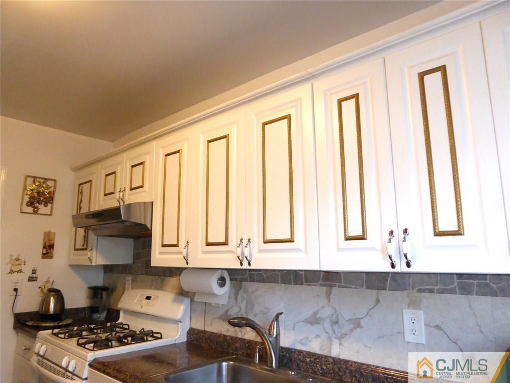 20 Miko Road Edison, NJ 08817 - Photo 9 of 19 a kitchen with stainless steel appliances a sink a stove and white cabinets