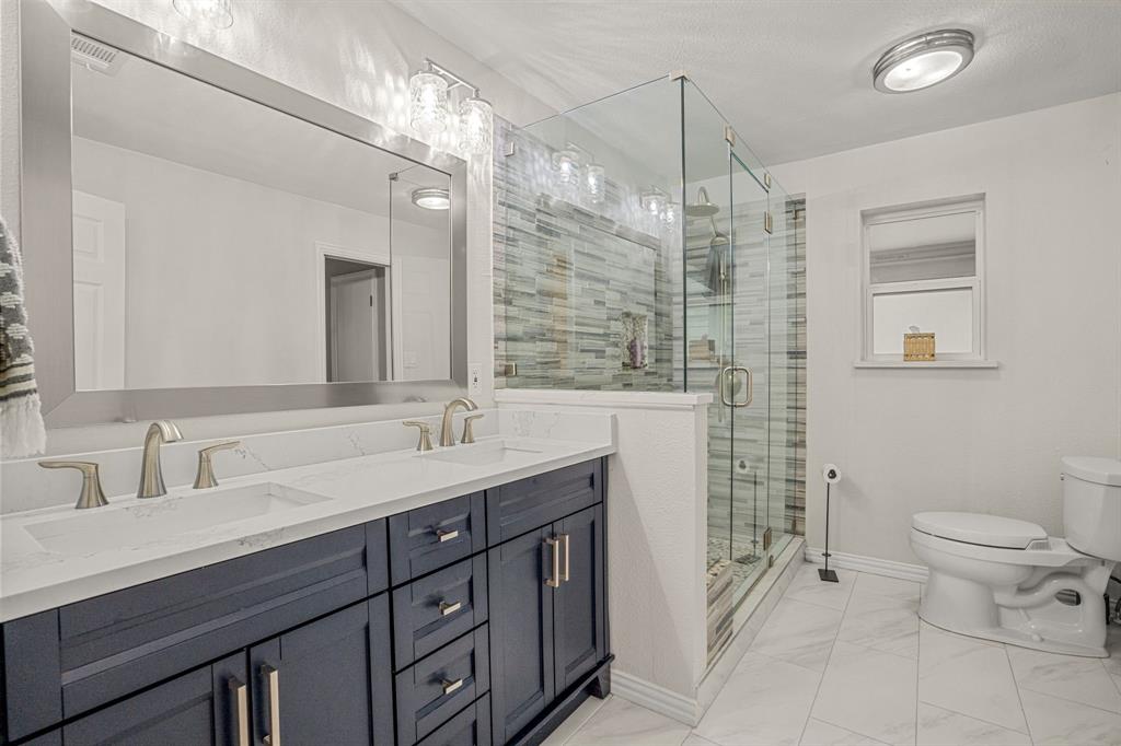 4529 Cloudview Road Fort Worth, TX 76109 - Photo 14 of 26 a bathroom with a double vanity sink toilet and a mirror