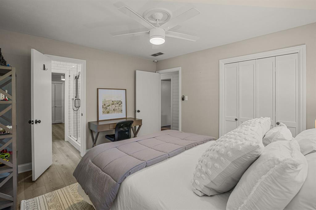 4529 Cloudview Road Fort Worth, TX 76109 - Photo 19 of 26 a bedroom with a bed and a chandelier