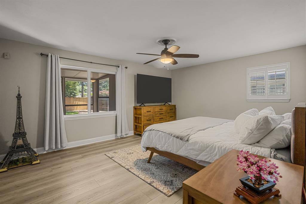 4529 Cloudview Road Fort Worth, TX 76109 - Photo 20 of 26 a bedroom with a bed and wooden floor