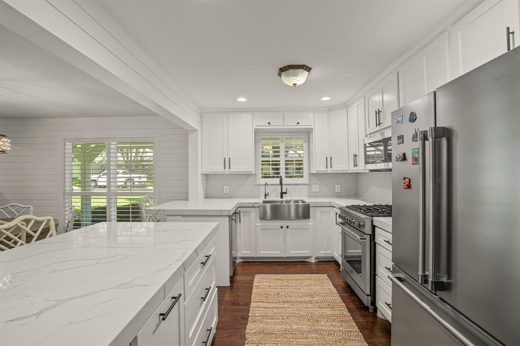 4529 Cloudview Road Fort Worth, TX 76109 - Photo 8 of 26 a kitchen with white cabinets and stainless steel appliances