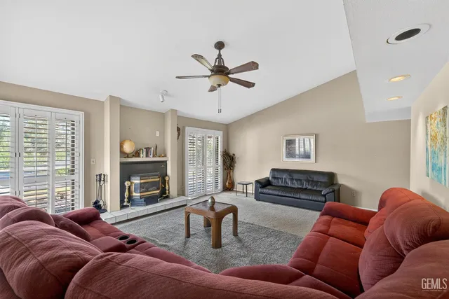 a living room with furniture fireplace and a large window
