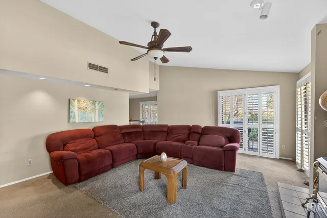 a living room with furniture a couch and a window