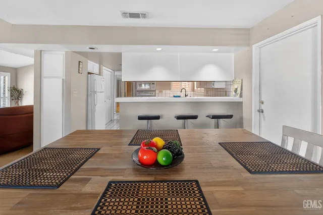 a living room with a rug and a table