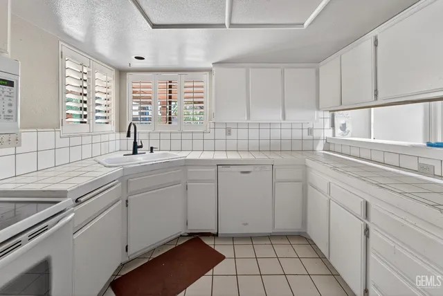 a kitchen with a sink cabinets and window