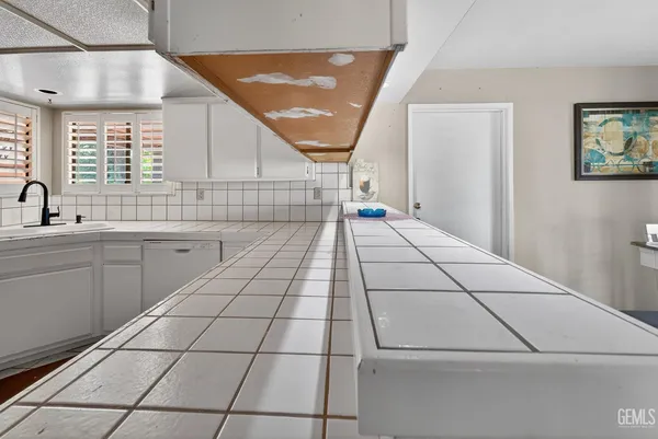 a view of a hallway with wooden floor and a bathroom
