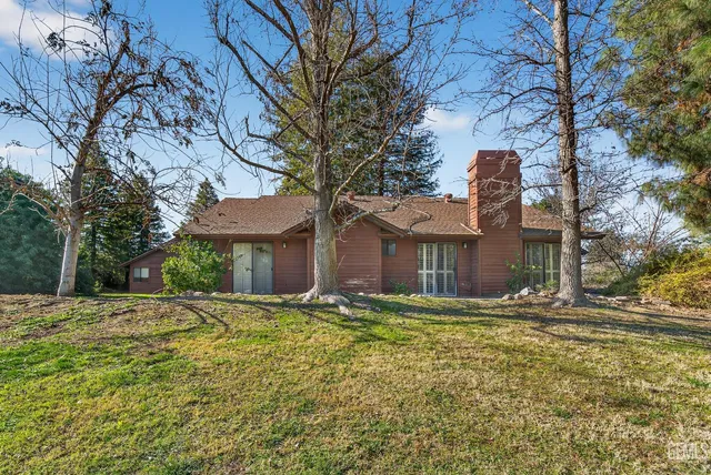 a view of a house with a yard and sitting area