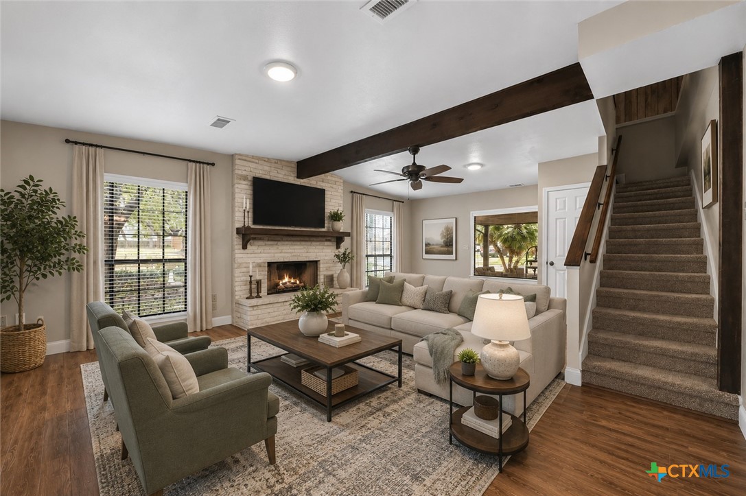 102 Rivercrest Street Luling, TX 78648 - Photo 2 of 36 a living room with furniture and a fireplace