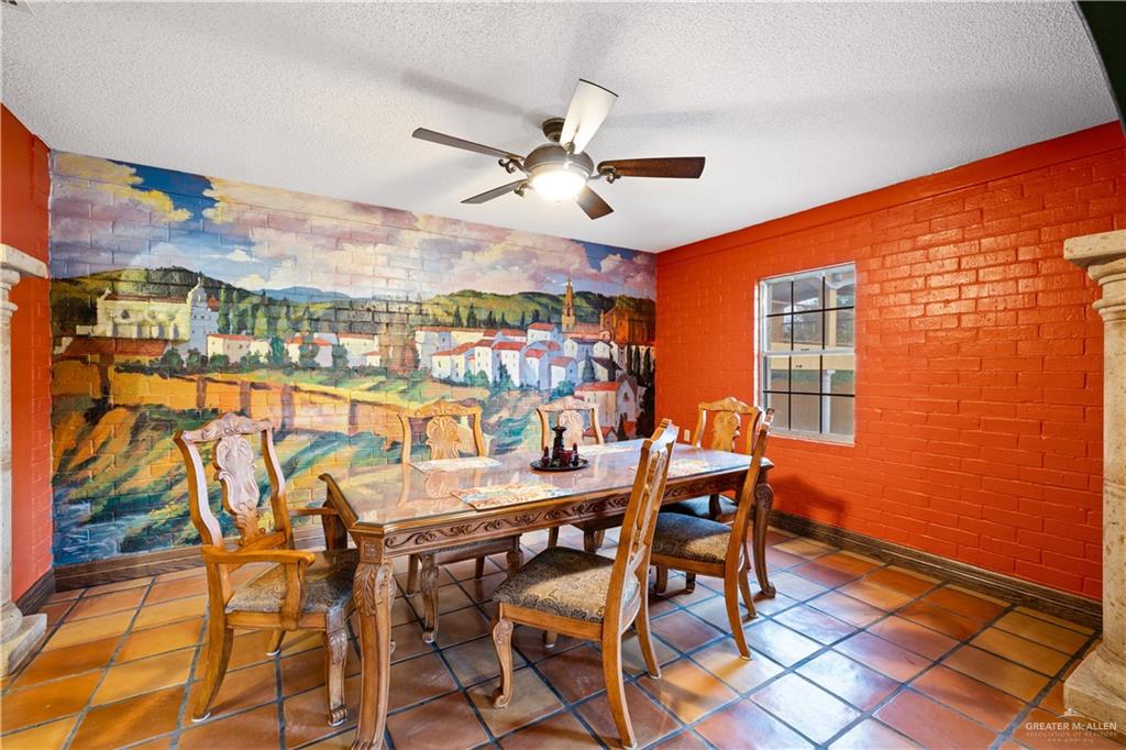 610 North Texas Street Rio Grande City, TX 78582 - Photo 7 of 23 a view of a dining room with furniture and a floor to ceiling window
