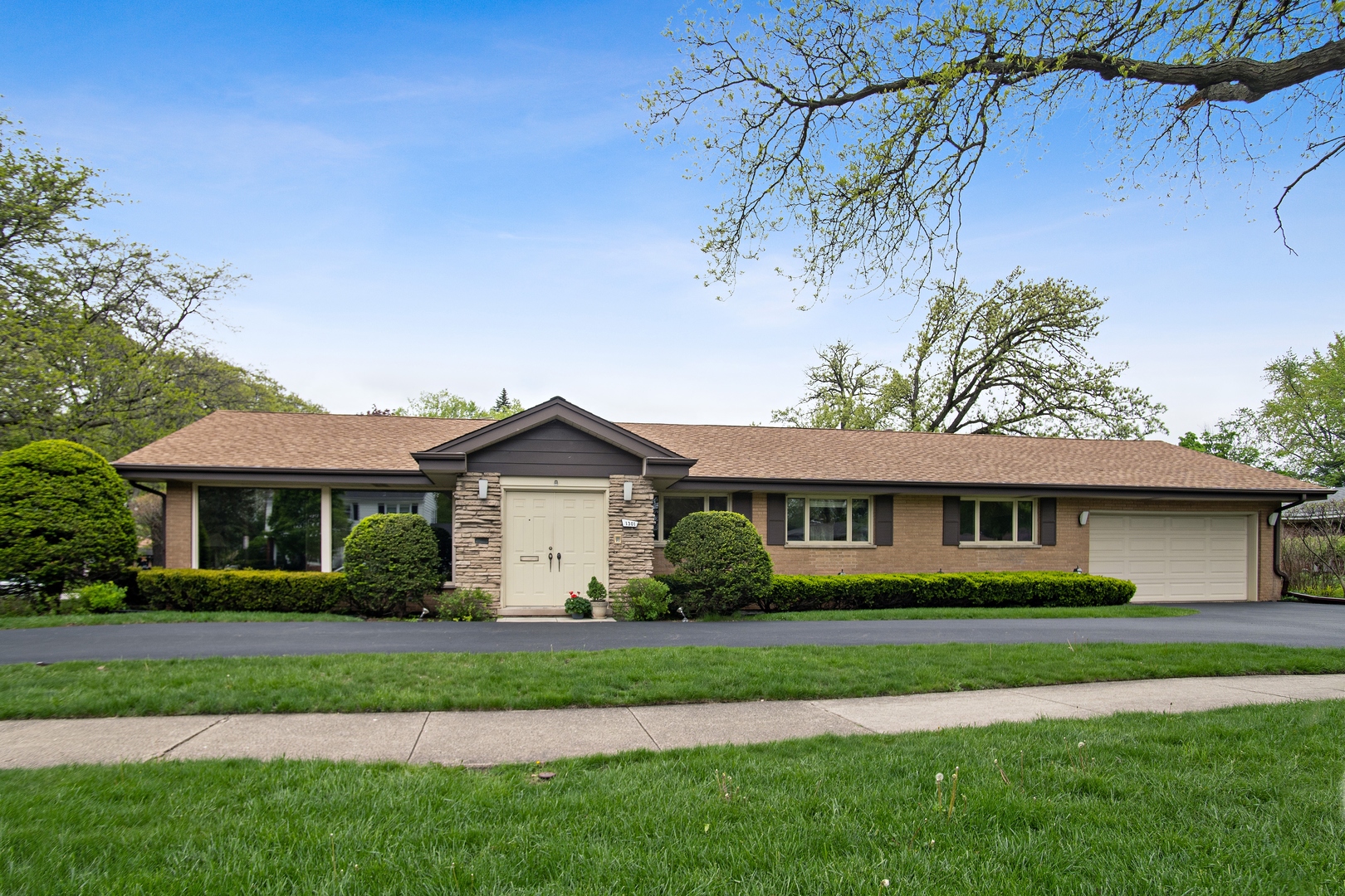 a front view of a house with a garden