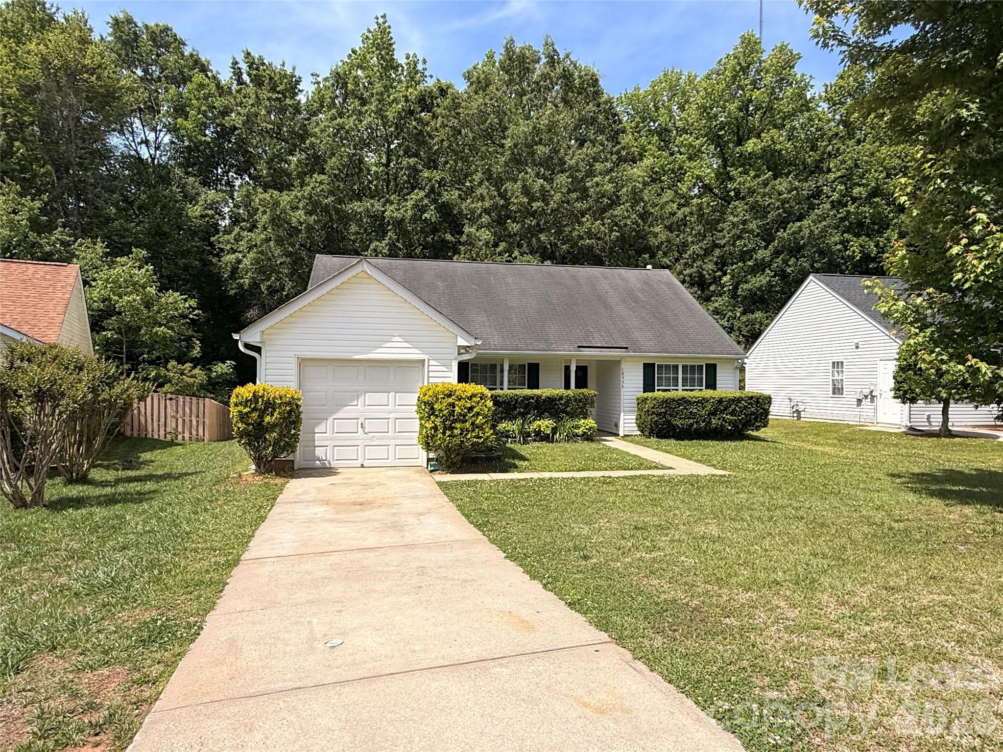 a view of a yard in front view of a house