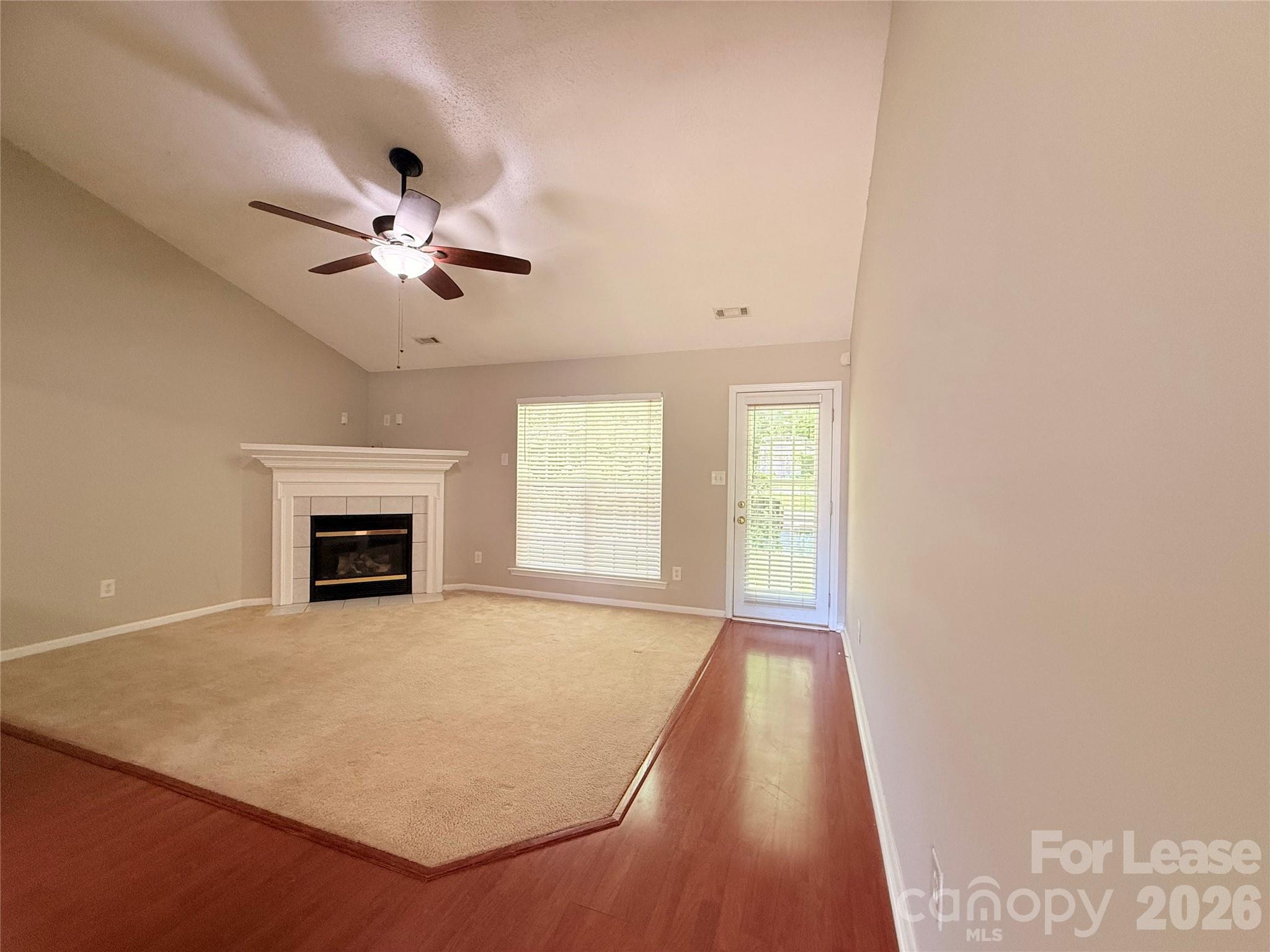 10553 Gold Pan Road Charlotte, NC 28215 - Photo 4 of 15 an empty room with windows and fireplace