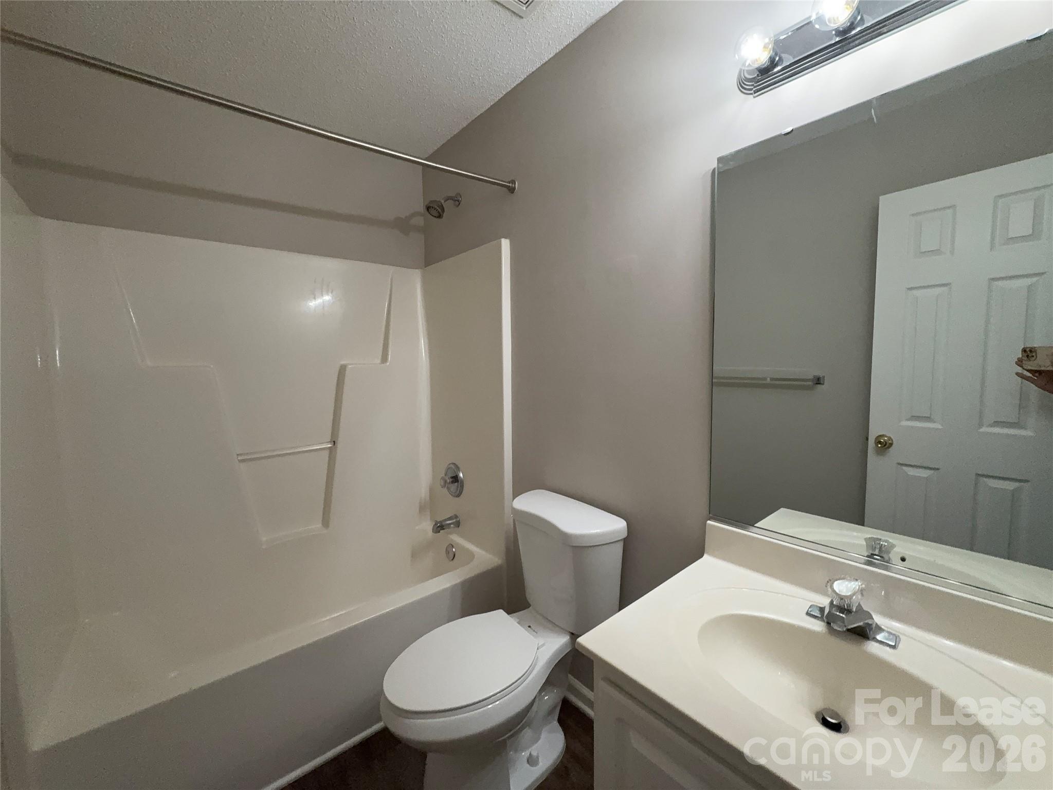 10553 Gold Pan Road Charlotte, NC 28215 - Photo 9 of 15 a bathroom with a sink toilet and shower