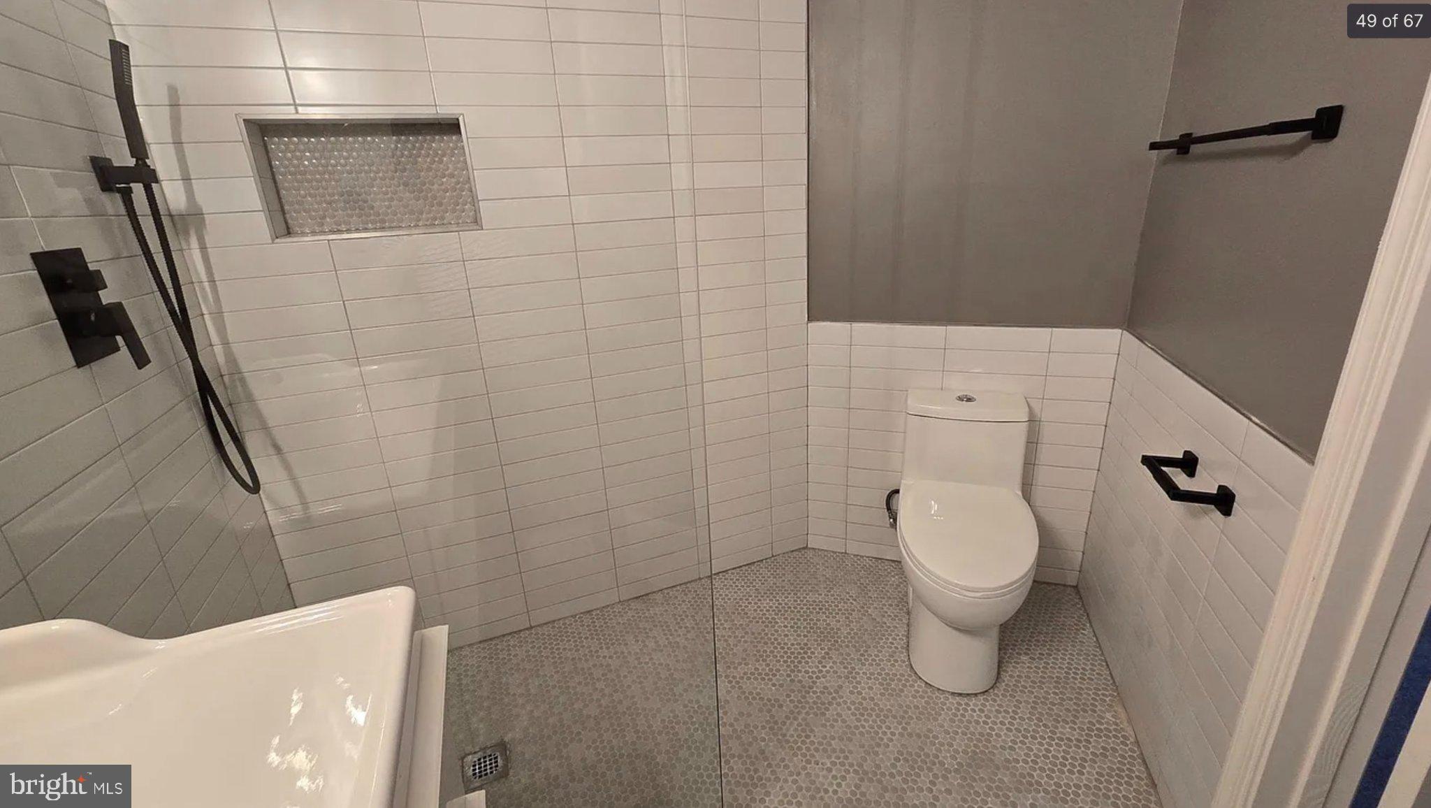 3906 Valley Ridge Drive Fairfax, VA 22033 - Photo 47 of 58 Sleek modern bathroom with elegant tiles.