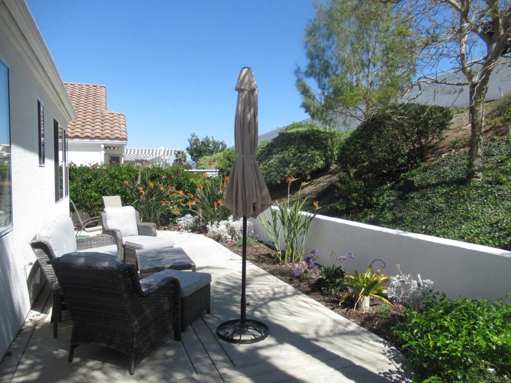 6033 Patmos Way Oceanside, CA 92056 - Photo 20 of 41 a view of a patio with table and chairs and potted plants