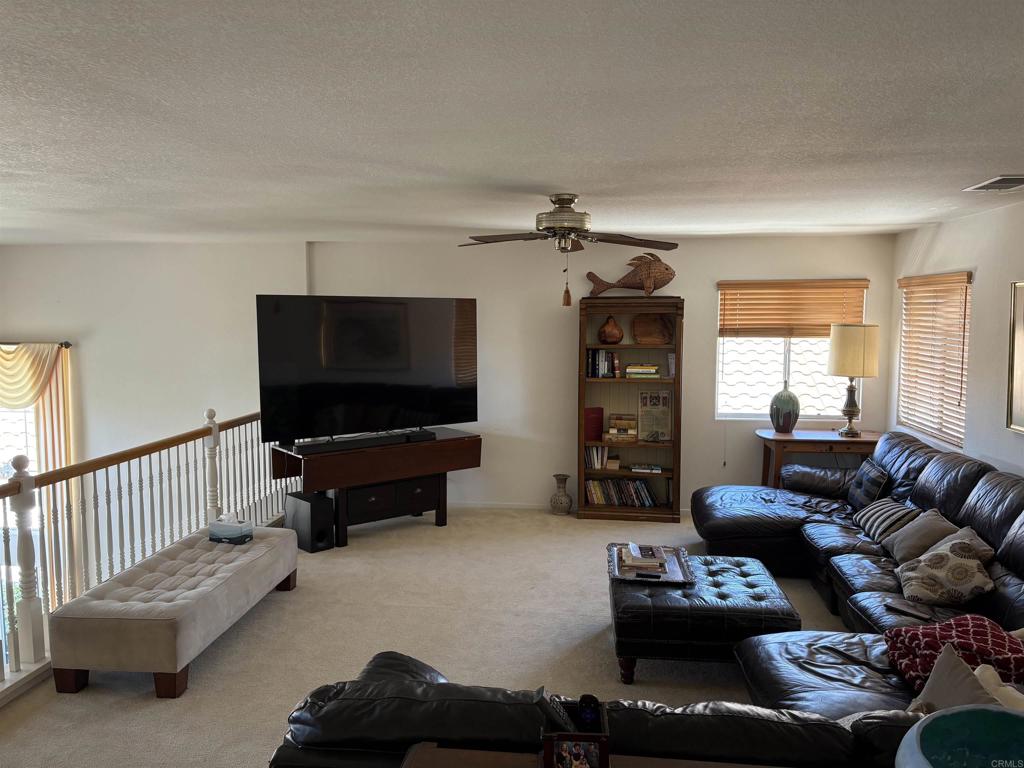 6033 Patmos Way Oceanside, CA 92056 - Photo 25 of 41 a living room with furniture and a flat screen tv