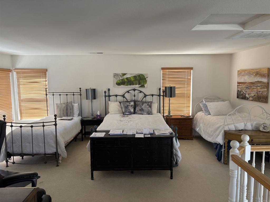 6033 Patmos Way Oceanside, CA 92056 - Photo 26 of 41 a bedroom with furniture and a large window