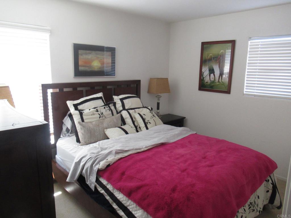 6033 Patmos Way Oceanside, CA 92056 - Photo 27 of 41 a bed sitting in a bedroom next to a window