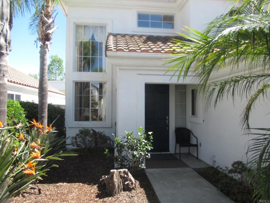 6033 Patmos Way Oceanside, CA 92056 - Photo 6 of 41 a front view of a house with a garden