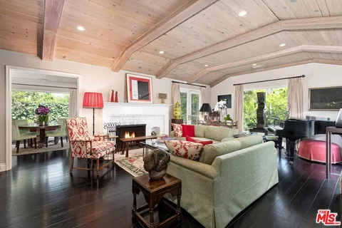 a living room with patio furniture and a fireplace