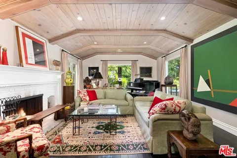a living room with furniture fireplace and flat screen tv
