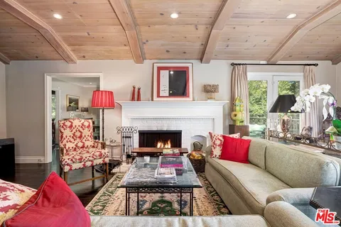 a dining room with furniture a rug and wooden floor