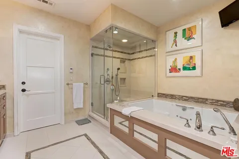 a view of a kitchen with refrigerator and wooden floor