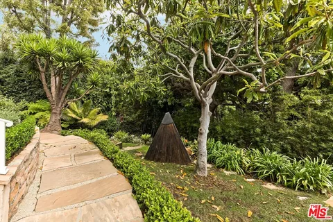 a pathway of a house with a yard