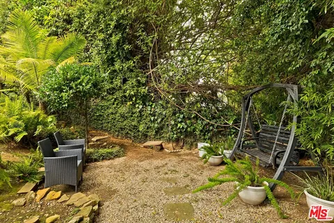 a view of a house with potted plants