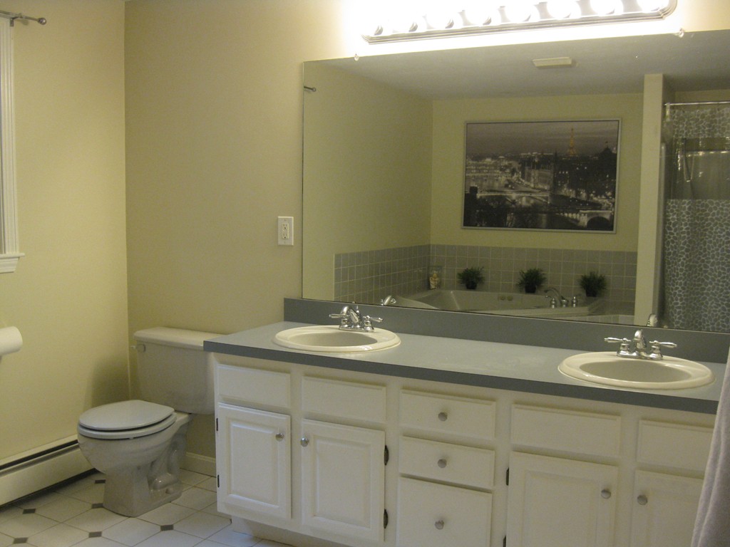 8 Abbey Road Walpole, MA 02071 - Photo 20 of 30 a bathroom with a toilet sink and mirror