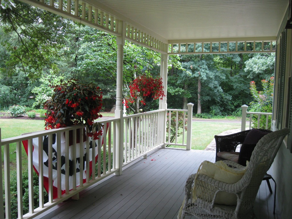 8 Abbey Road Walpole, MA 02071 - Photo 3 of 30 a view of a chairs and table in the balcony