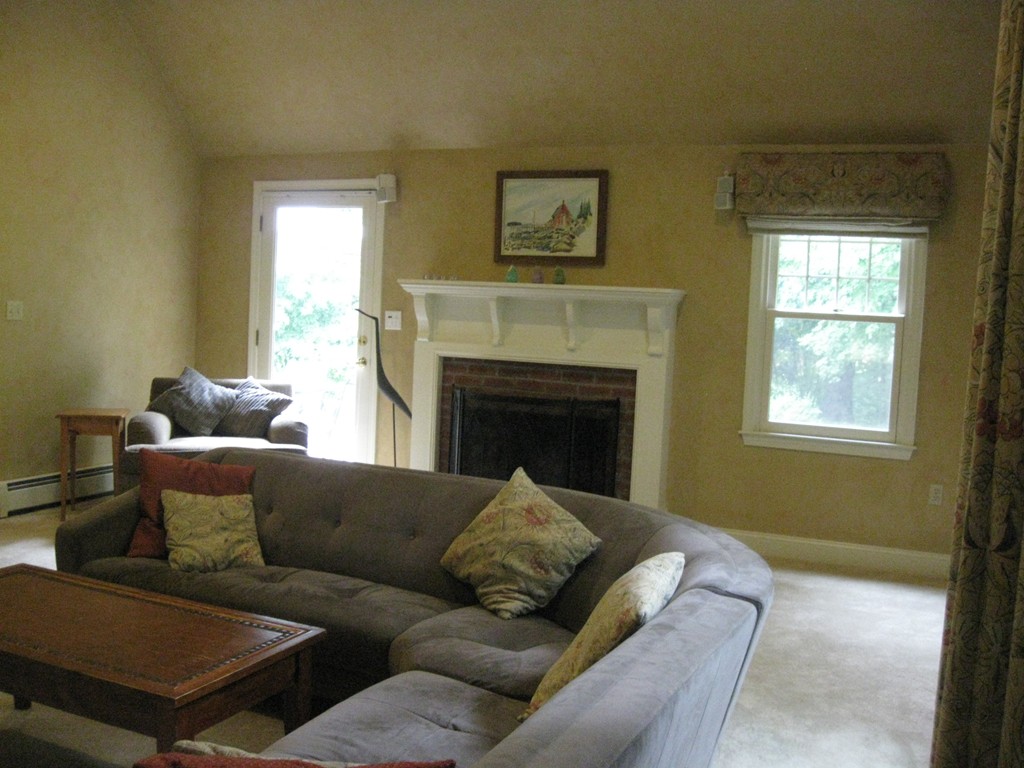 8 Abbey Road Walpole, MA 02071 - Photo 6 of 30 a living room with furniture and a fireplace