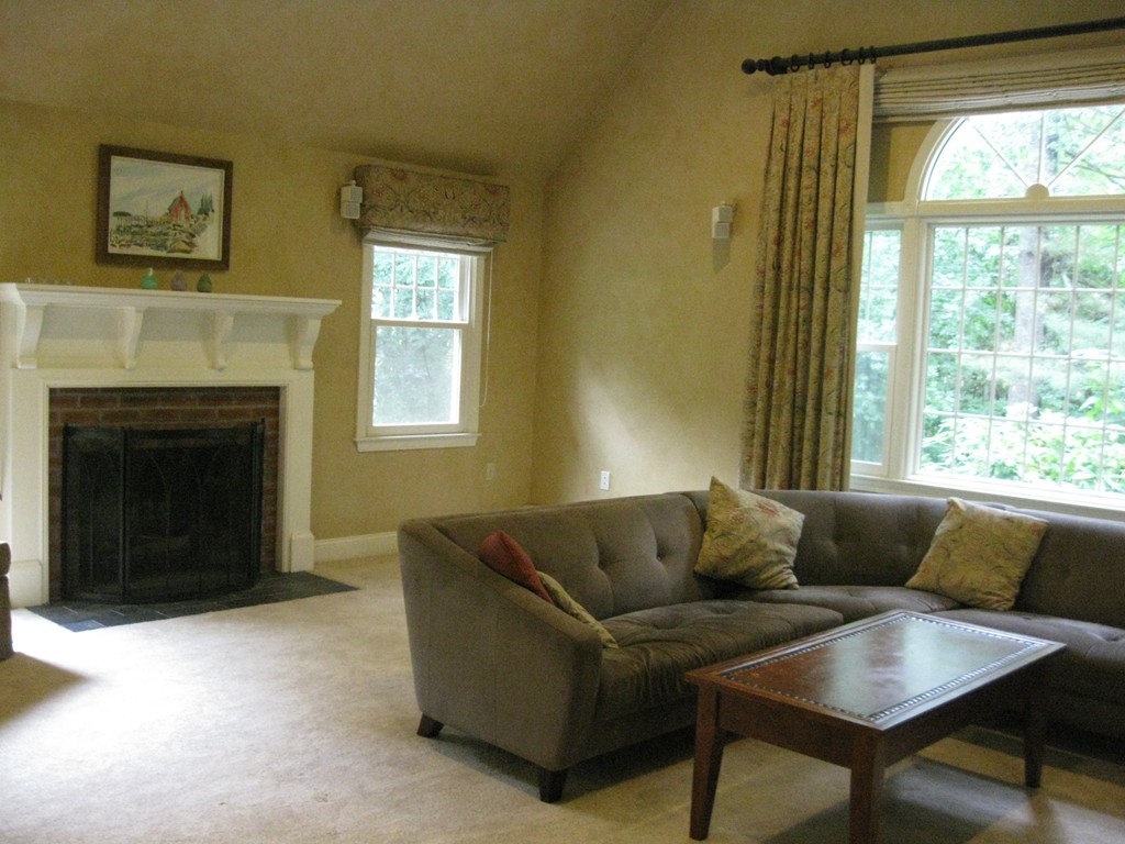 8 Abbey Road Walpole, MA 02071 - Photo 7 of 30 a living room with furniture and a fireplace