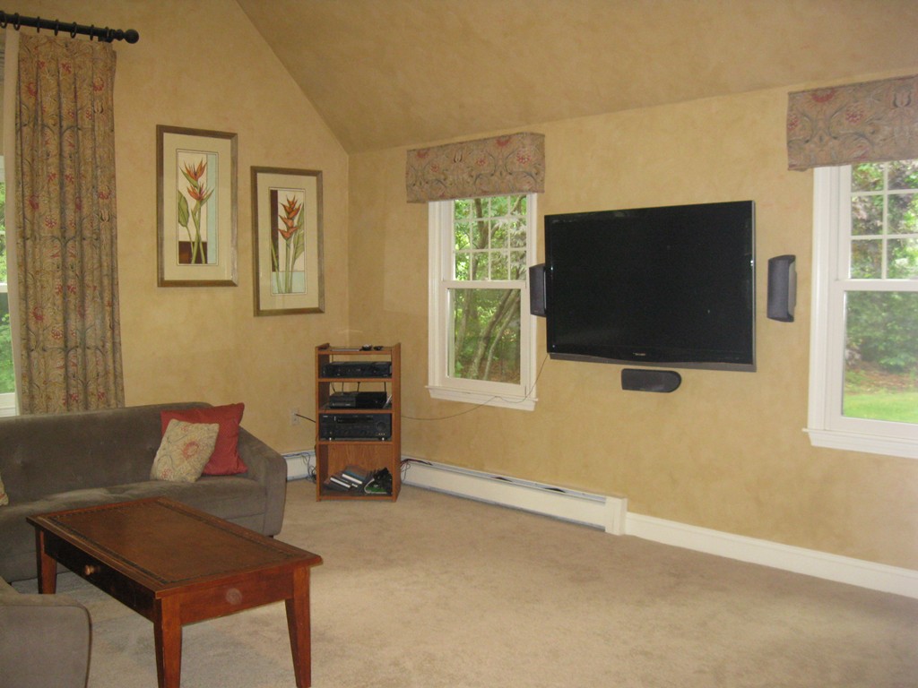 8 Abbey Road Walpole, MA 02071 - Photo 8 of 30 a living room with furniture and a flat screen tv