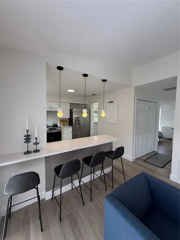 a kitchen with a table chairs and a refrigerator