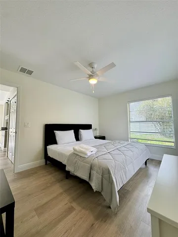 a bedroom with a bed and window