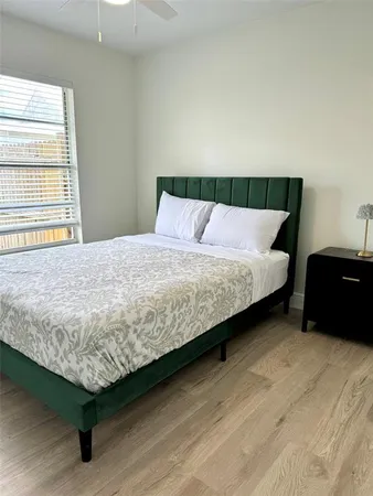 a bedroom with a bed and window