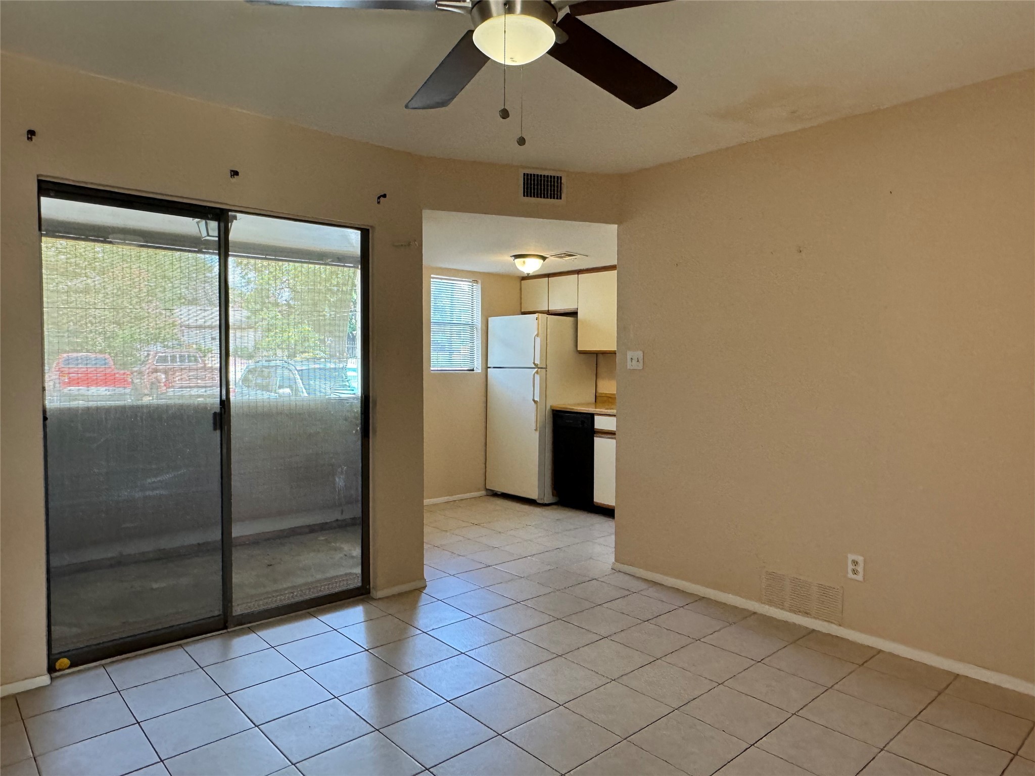 2500 Burleson Road, Unit 403 Austin, TX 78741 - Photo 1 of 1 a view of a refrigerator in kitchen and an empty room