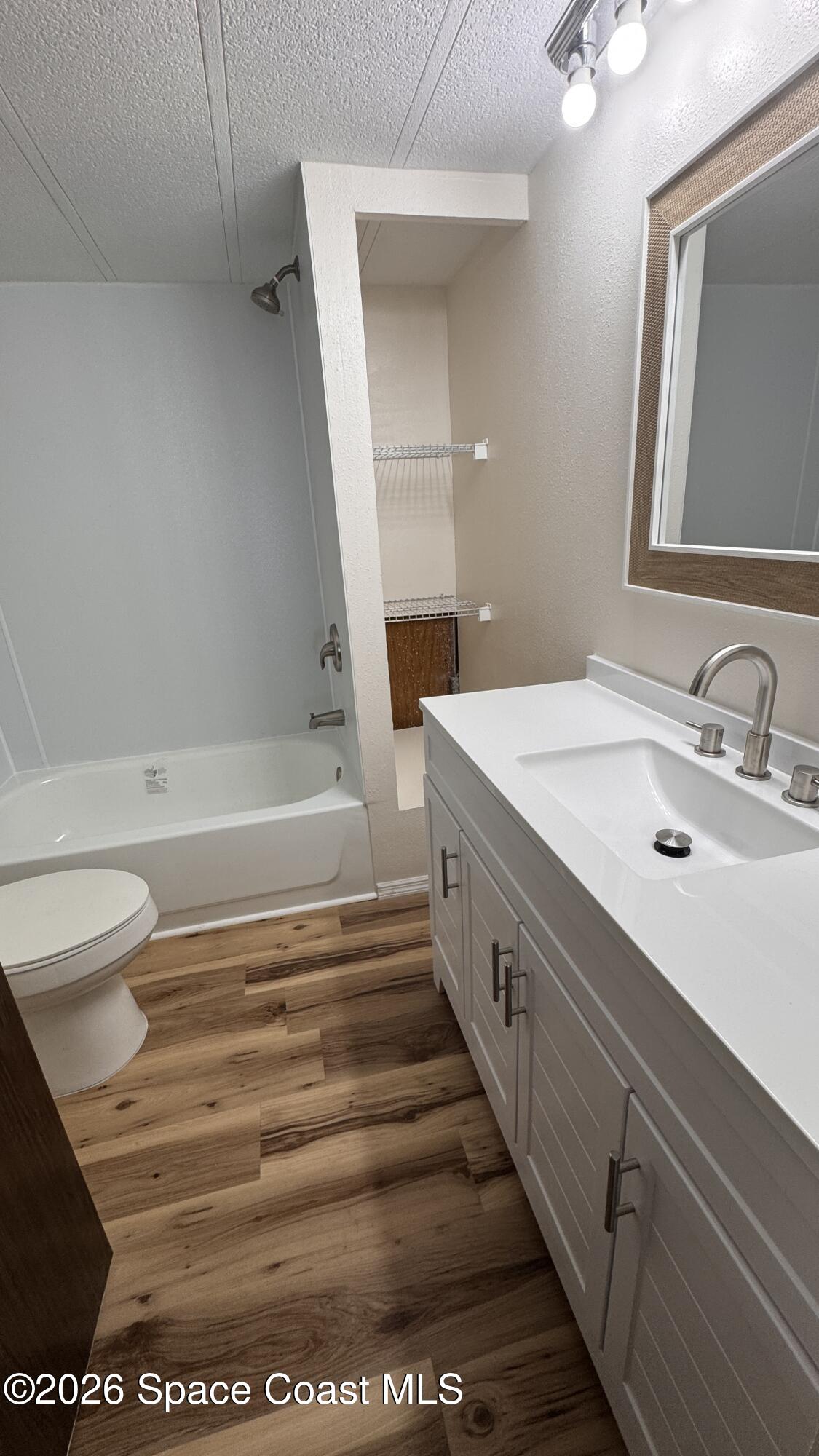 2522 Amberly Road Northeast Palm Bay, FL 32905 - Photo 10 of 13 a bathroom with a sink a toilet and a mirror