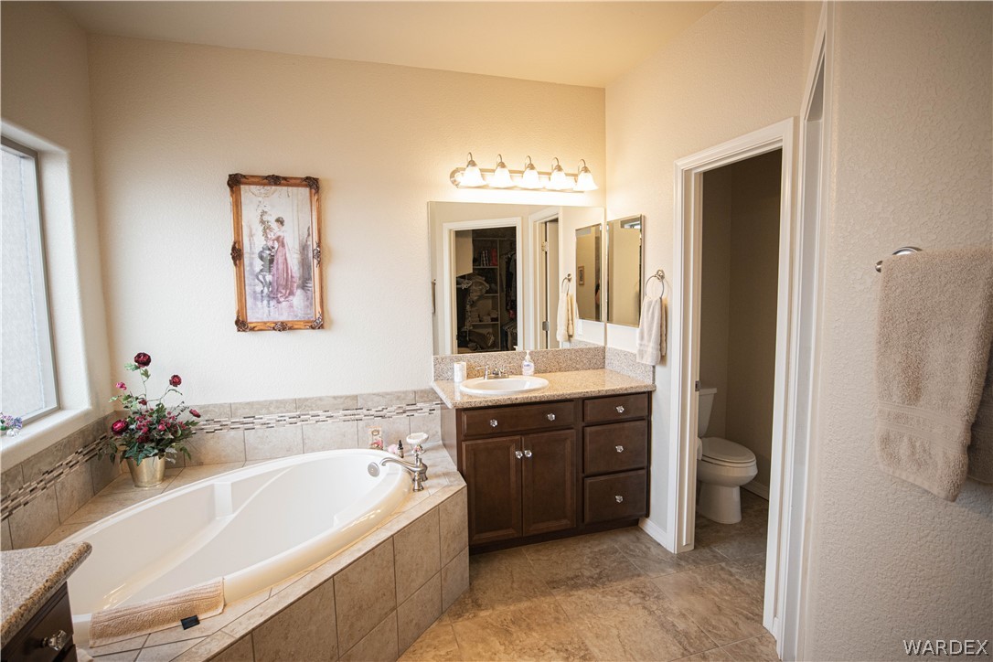4873 North Neal Ranch Road Kingman, AZ 86401 - Photo 18 of 33 a spacious bathroom with a tub sink and mirror