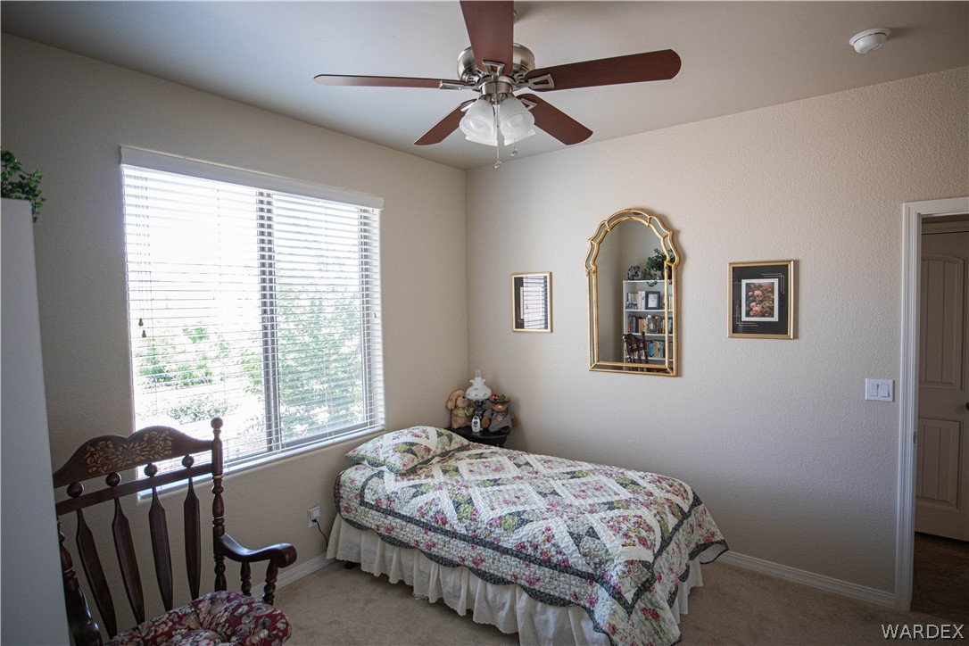 4873 North Neal Ranch Road Kingman, AZ 86401 - Photo 21 of 33 a bedroom with a bed and a window
