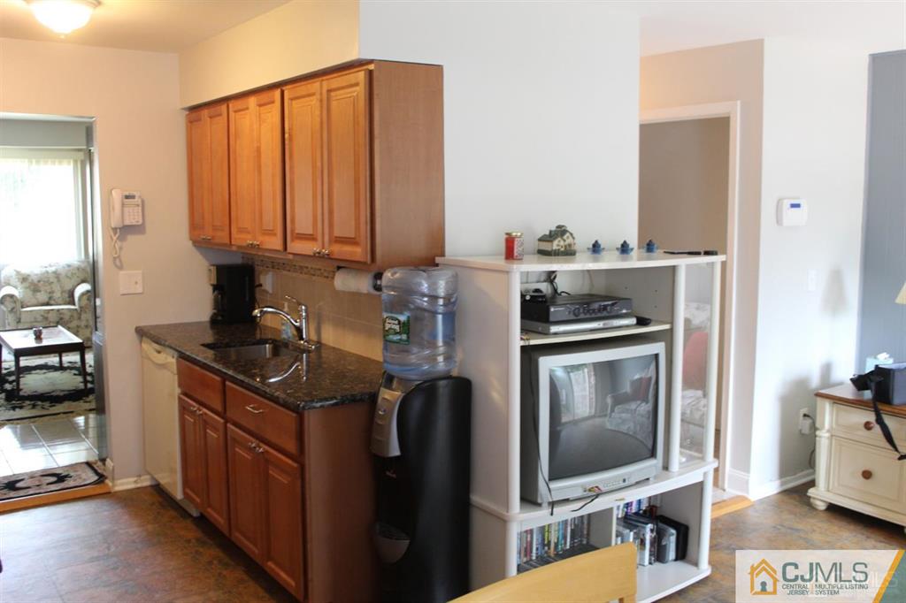 2 R Quincy Circle, Unit R2 Dayton, NJ 08810 - Photo 5 of 18 a kitchen with stainless steel appliances granite countertop a stove a sink and a microwave