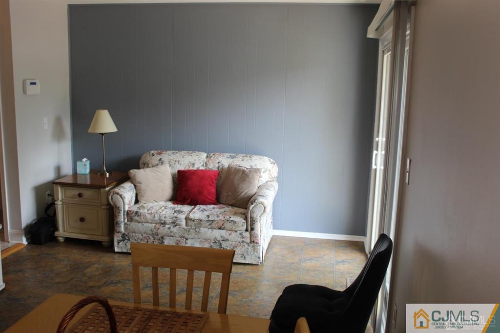2 R Quincy Circle, Unit R2 Dayton, NJ 08810 - Photo 6 of 18 a bedroom with a bed and a chair