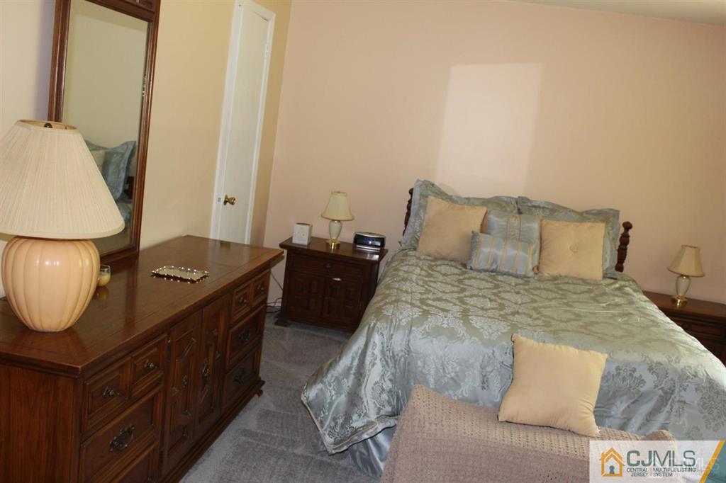 2 R Quincy Circle, Unit R2 Dayton, NJ 08810 - Photo 9 of 18 a bedroom with a bed and wooden floor