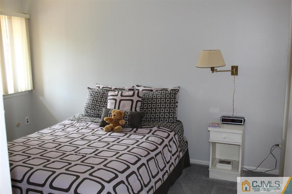 2 R Quincy Circle, Unit R2 Dayton, NJ 08810 - Photo 10 of 18 a bedroom with a bed and a night stand