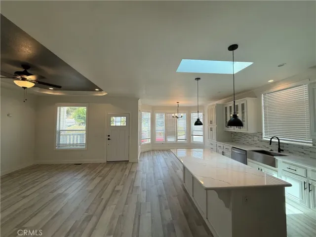 a large kitchen with cabinets a sink and dishwasher